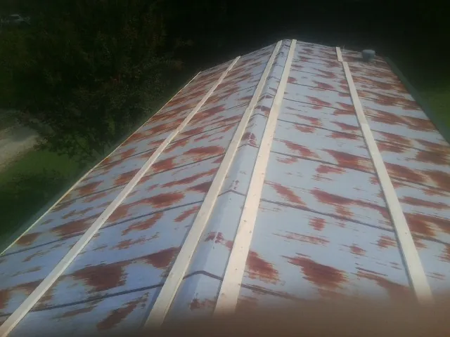 Rusted metal roof panels with new wood purlins before replacement — Storm Damage Roof Repair in Lecanto by Roofing Brothers